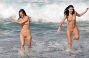 Girls Happily Splashing Among Crashing Waves