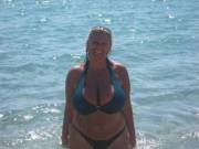 Tan Blonde Shows Off Her Massive Tits At The Beach
