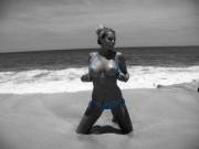 Showing Her Boobs On The Beach