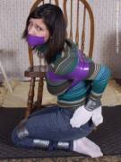 Socks Over Her Hand So She Can't Scrape Away The Tape