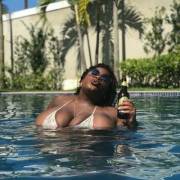 Enjoying A Beer As Her Massive Boobs Peek Out Of The Water