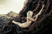 Blonde Laying On Enormous Rusty Chains