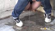A Big Wet Puddle Appears As This Sexy Babe In Denims Pisses Onto Concrete